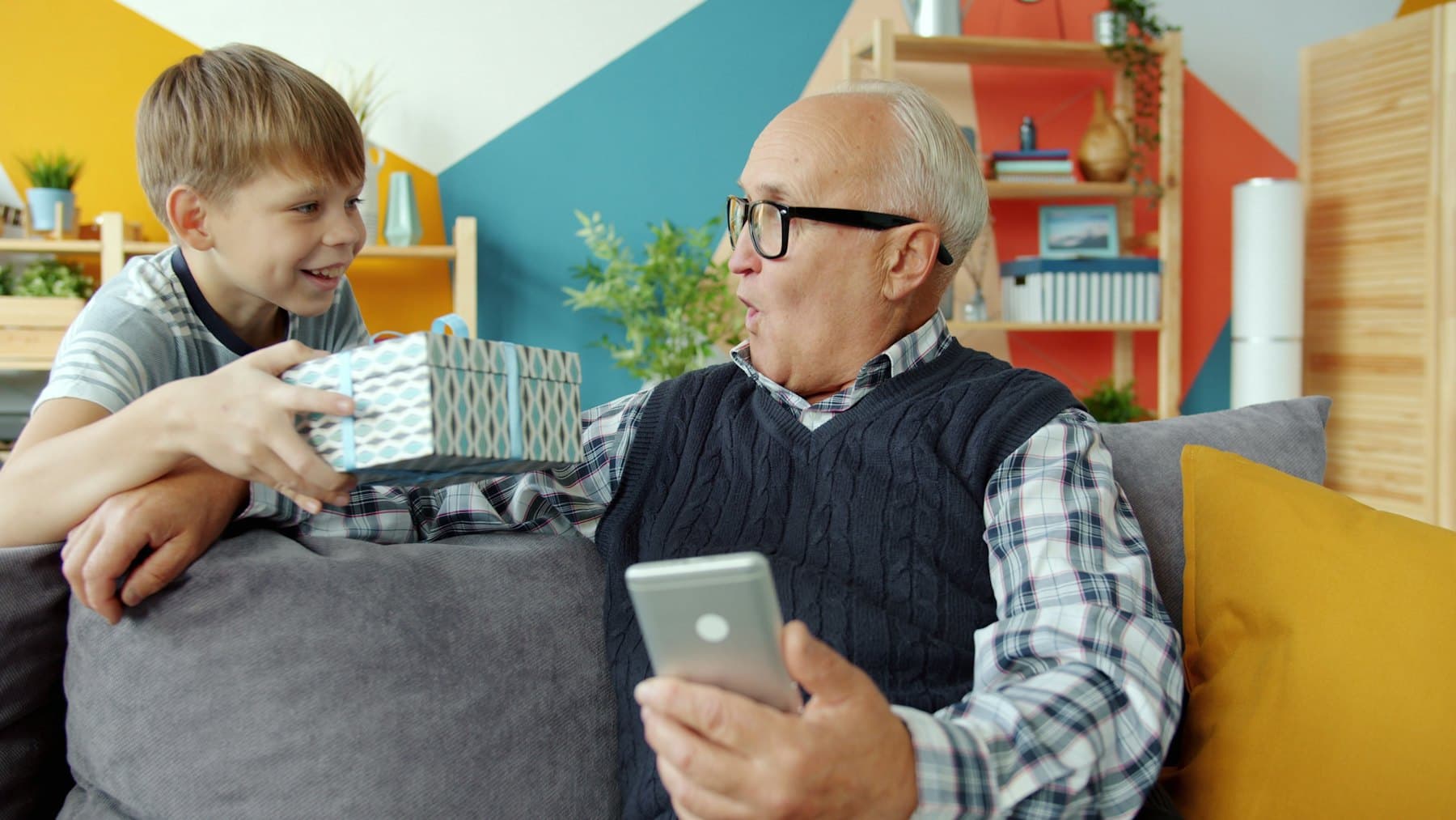 A boy giving his grandfather a gift