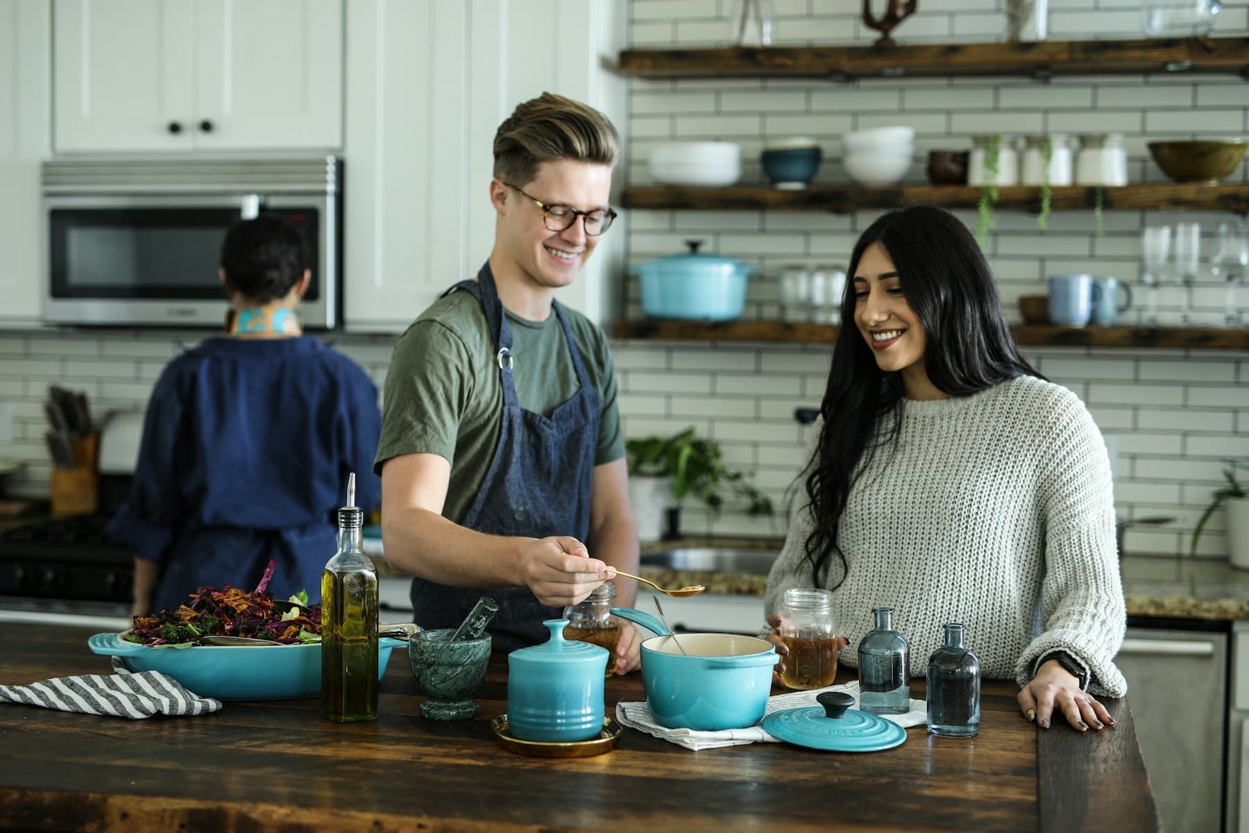 A couple cooking together in their kitchen