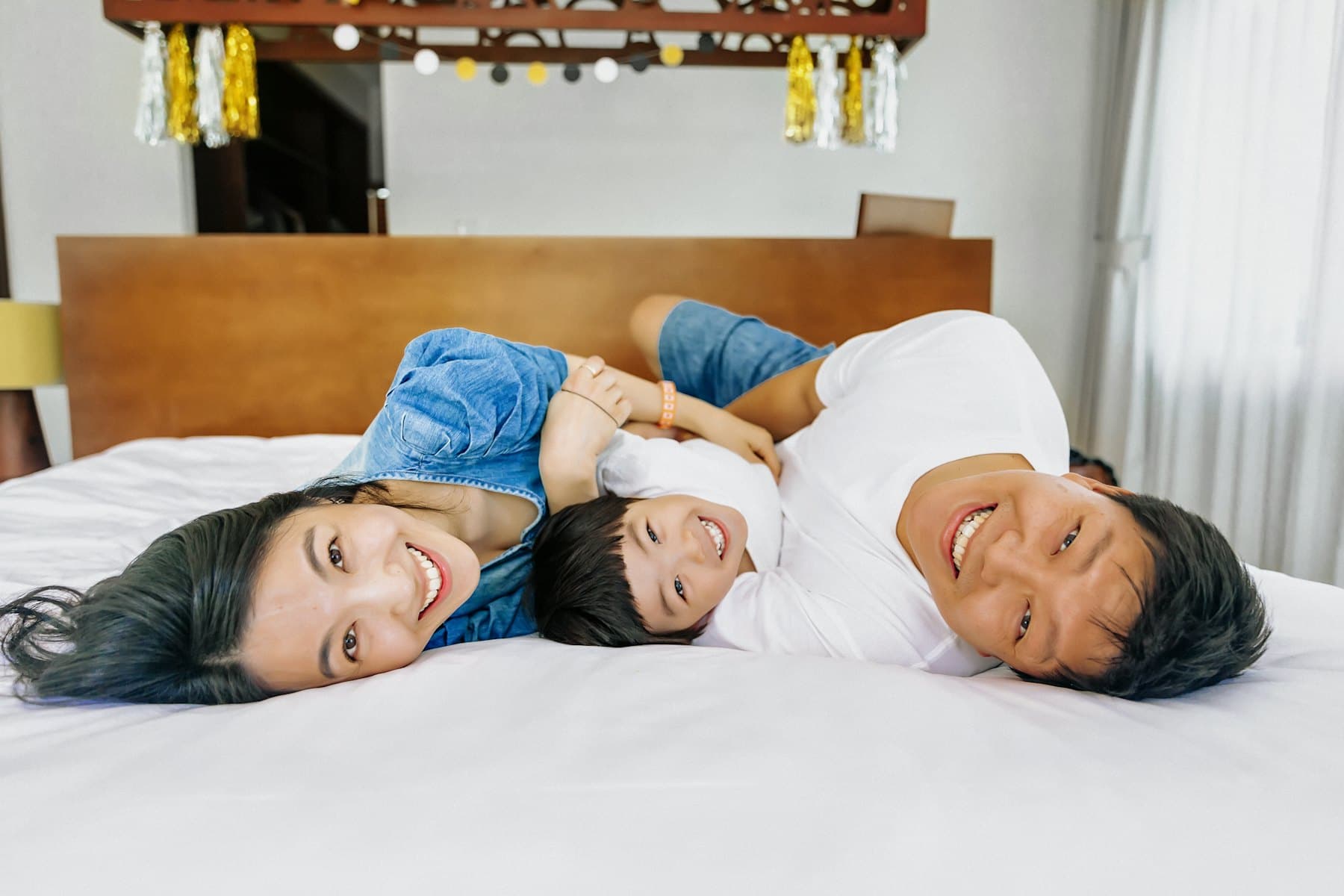 A family lying on a bed together