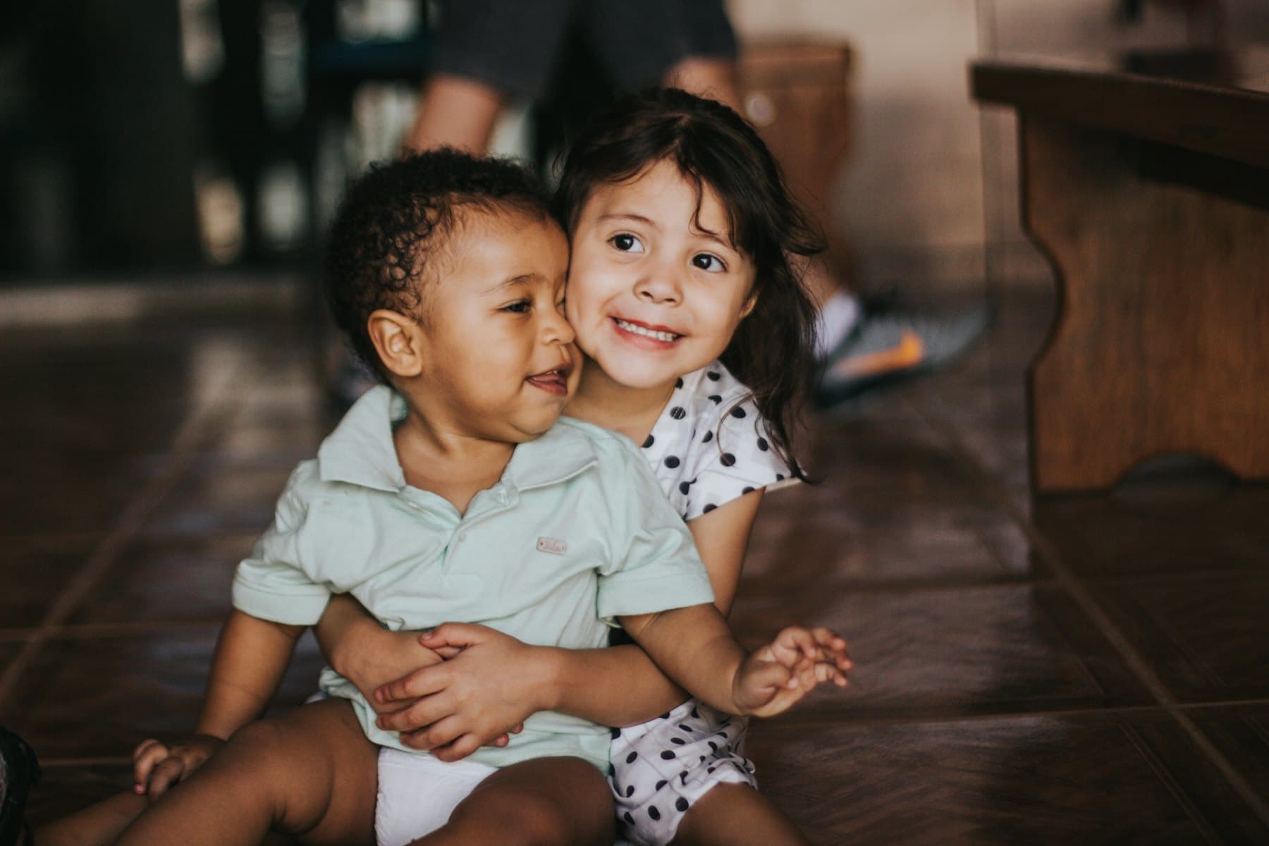 A girl hugging a boy