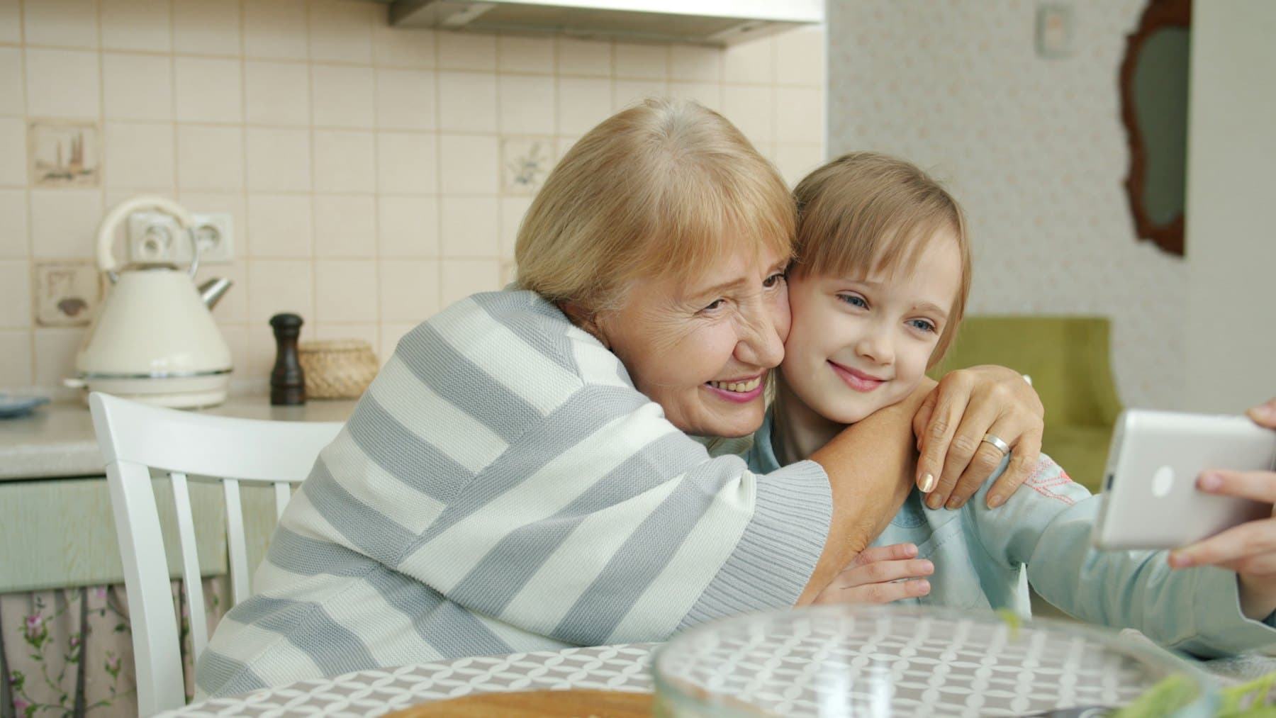 A grandmother and granddaughter taking a selfie