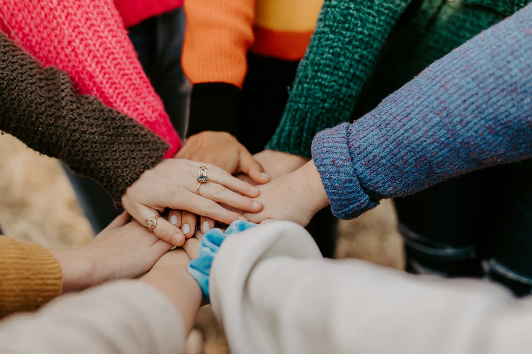 A group stacking their hands together