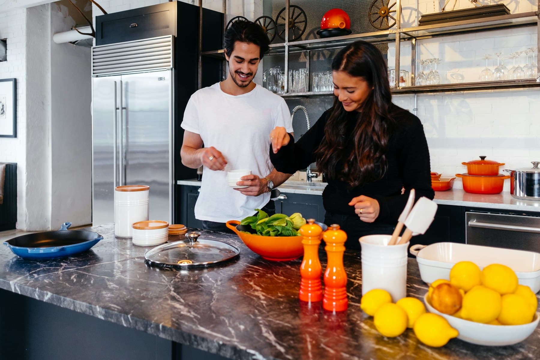 A man and a woman cooking together