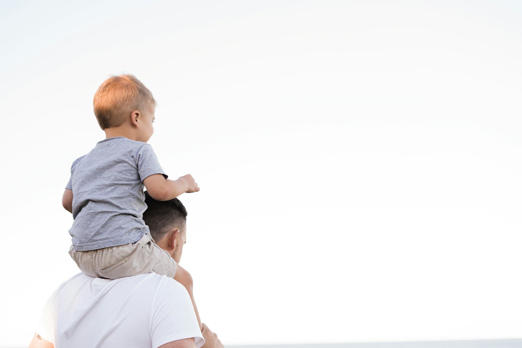 A man carrying a young boy