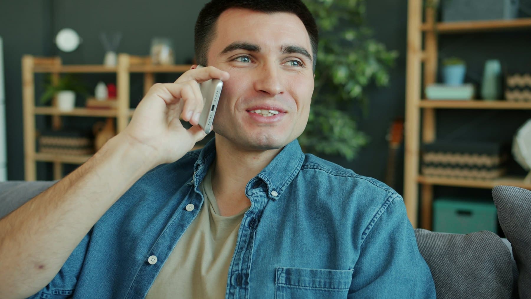 A man talking on his phone at home
