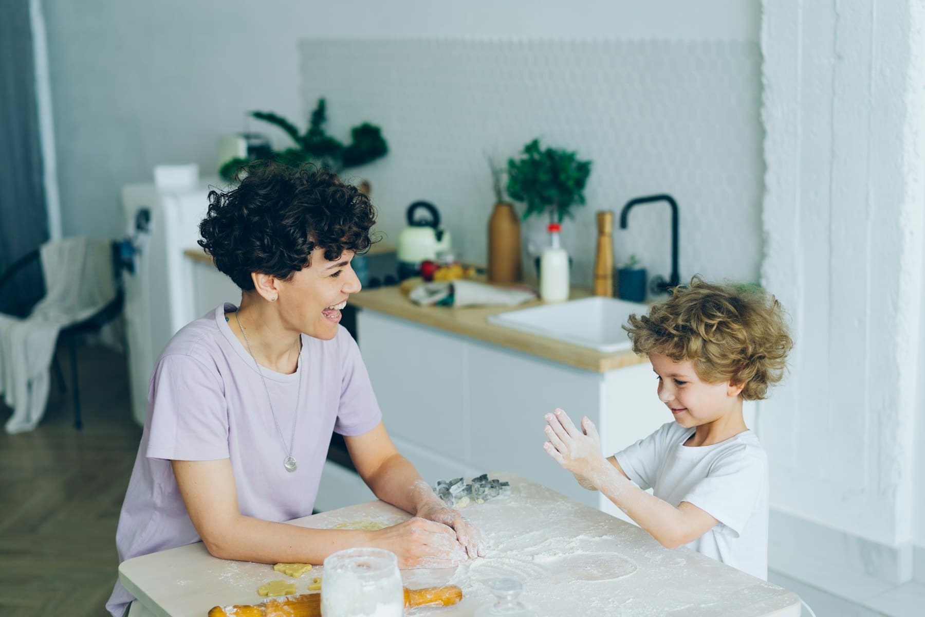 A woman and a child sitting at a kitchen table