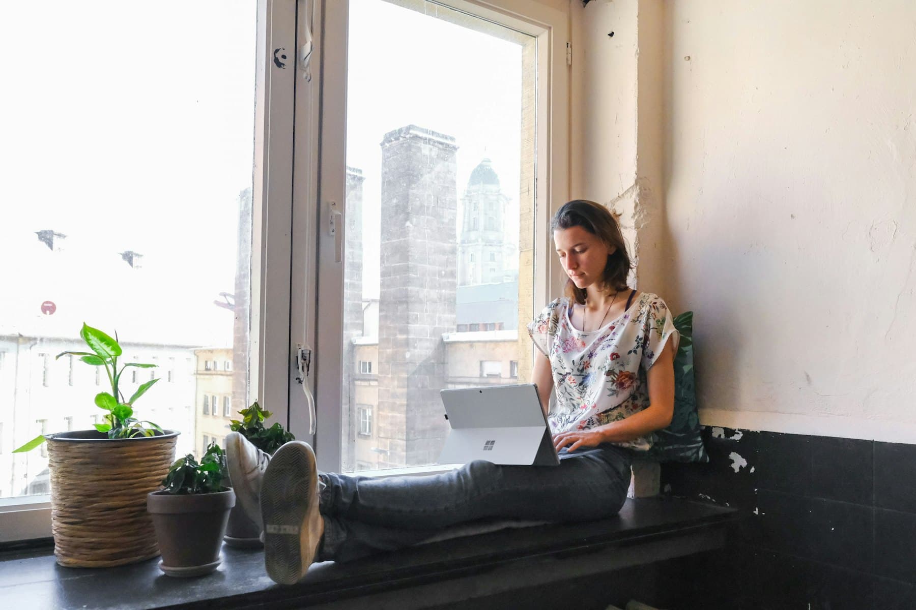 A woman sitting beside a window