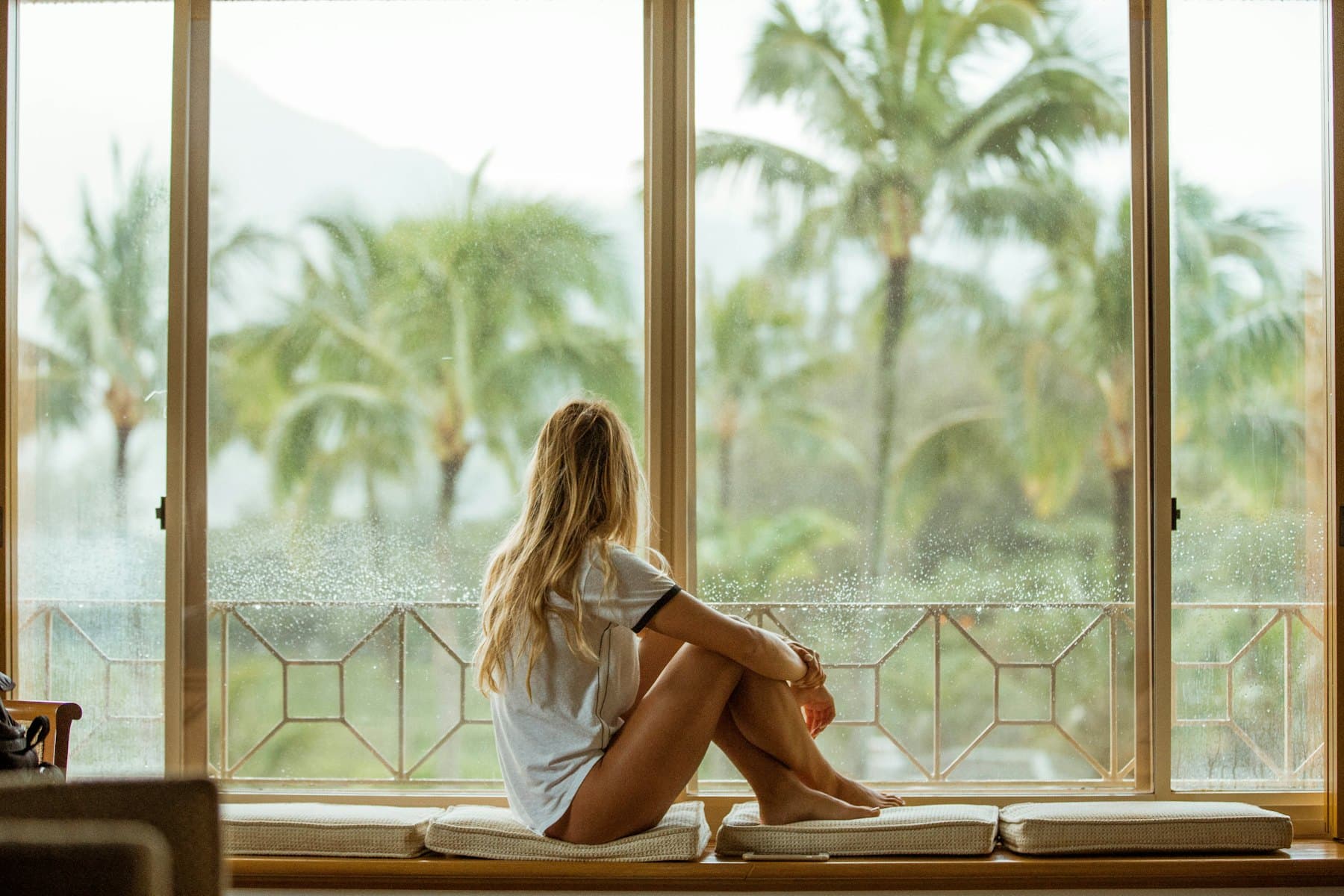 A woman sitting by a window