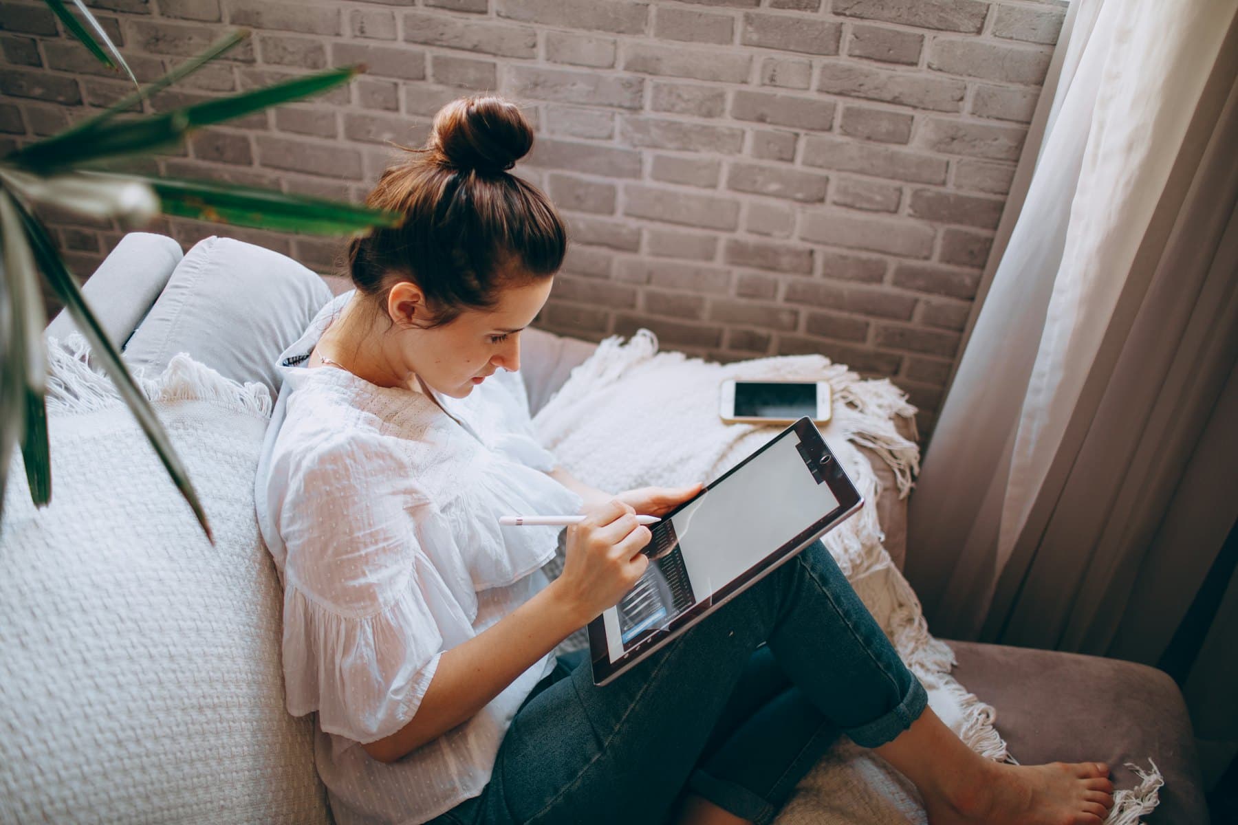 A woman sitting on a gray couch