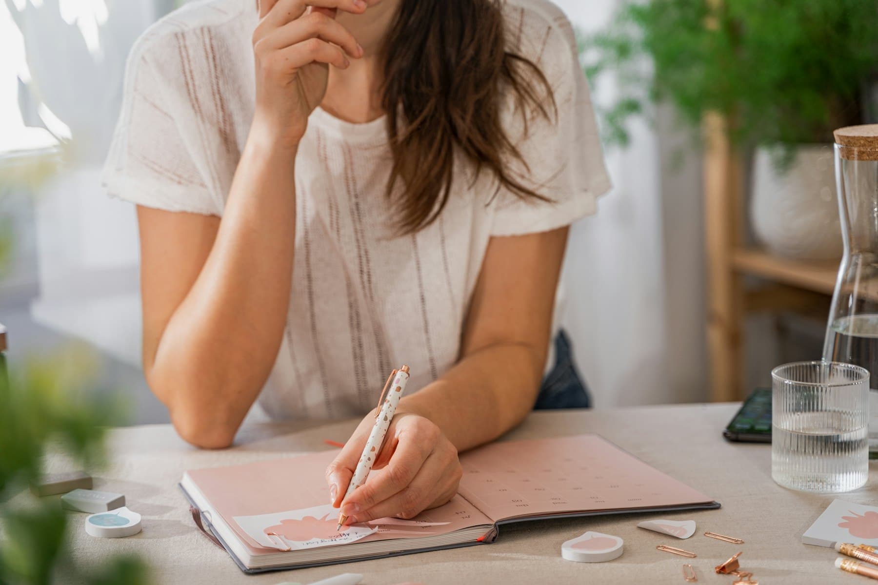 A woman writing on a sheet of paper