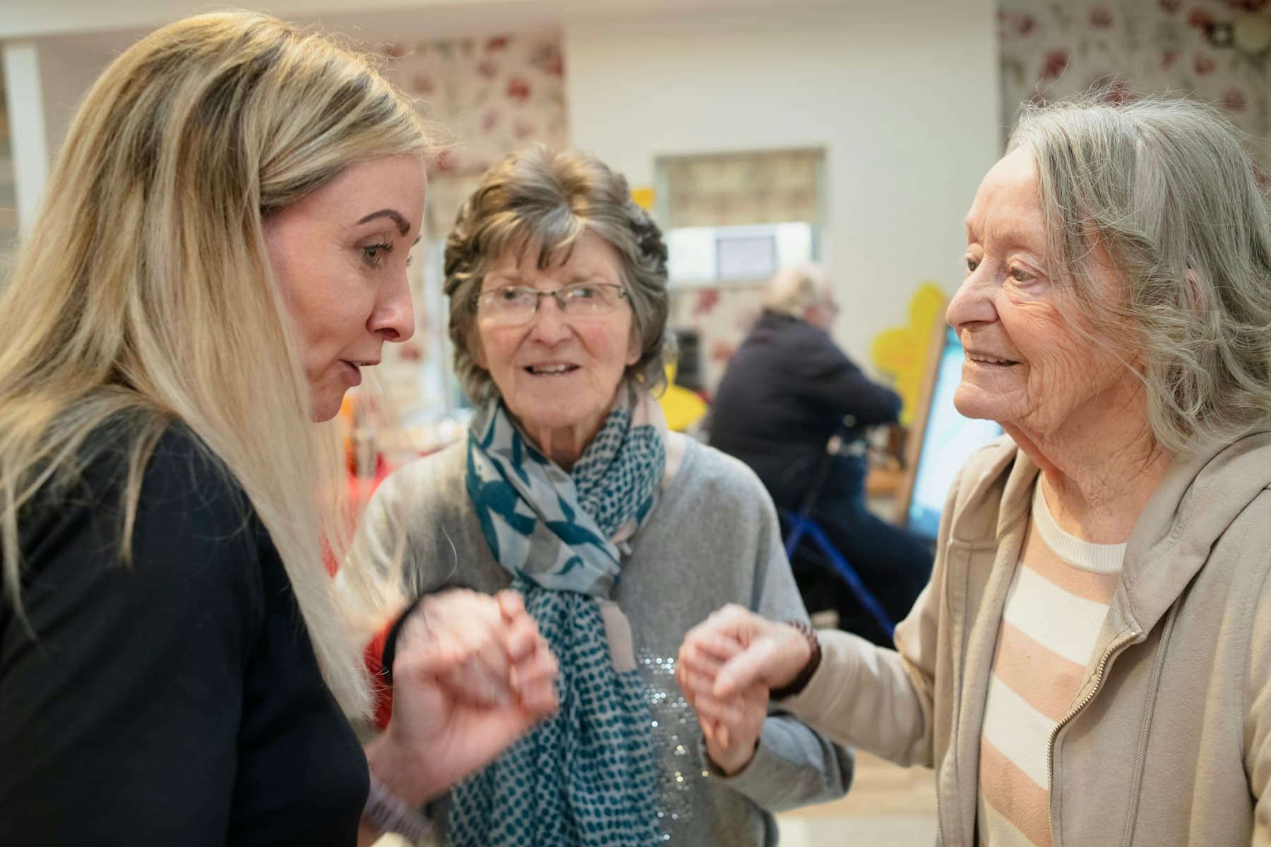 Three women talking together indoors