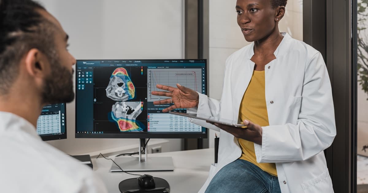 Doctor in a white coat explaining clinical results to a patient in a medical office