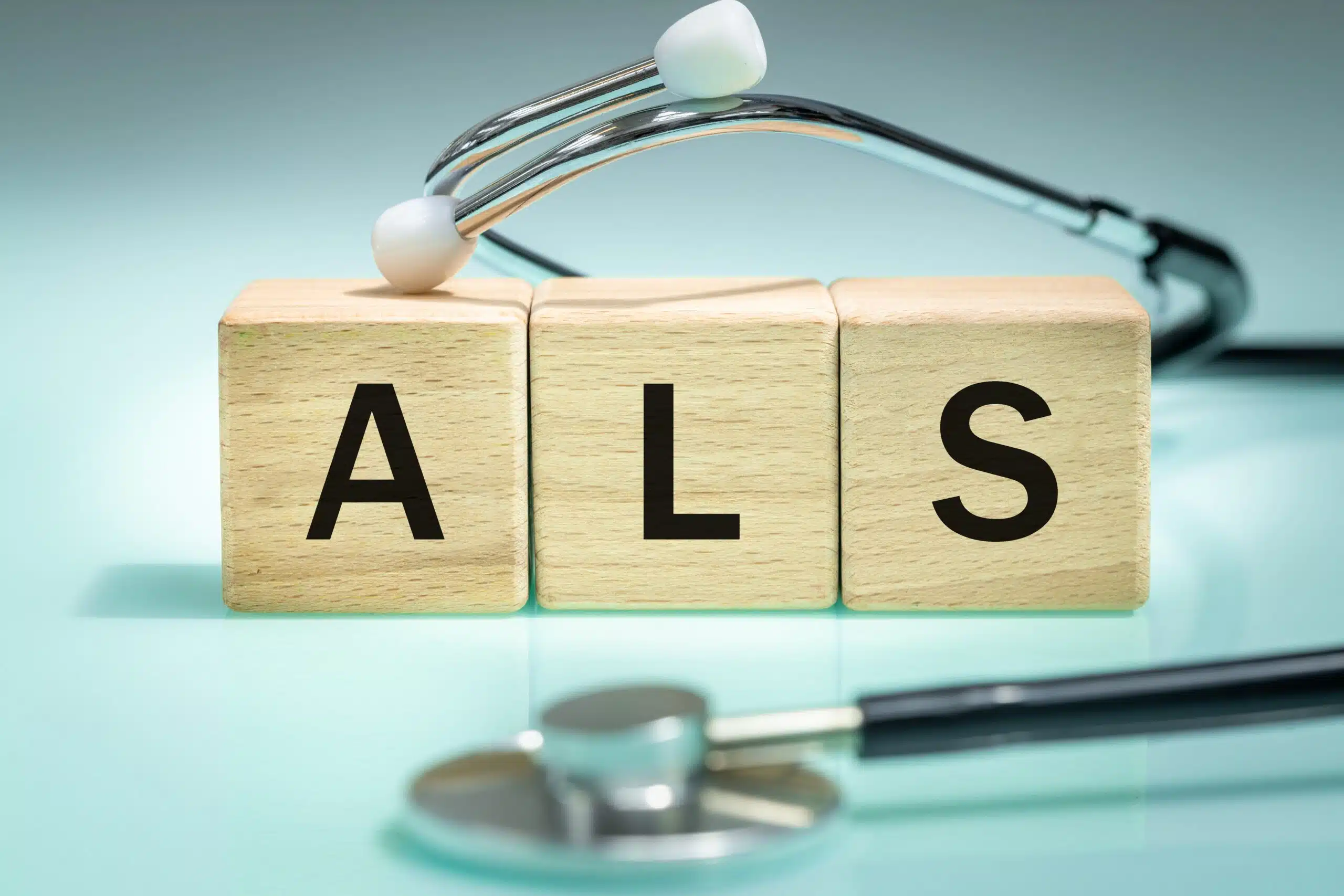 ALS amyotrophic lateral sclerosis letter blocks with stethoscope representing pridopidine Prevails Phase 3 clinical trial