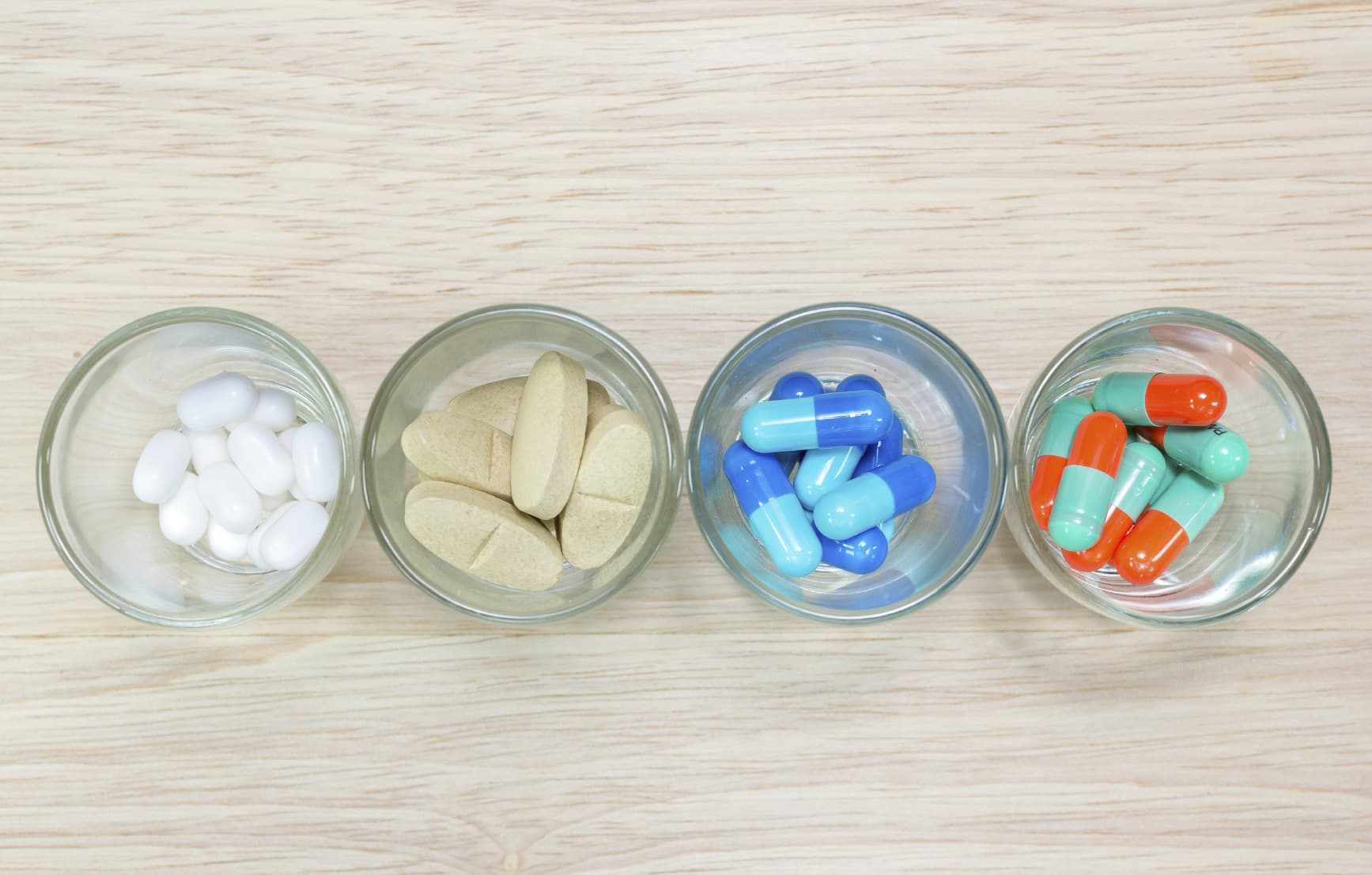 Colored pills and capsules representing placebos and randomization in rare disease clinical trials