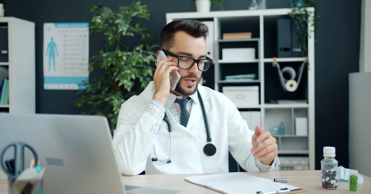 Doctor reviewing medical records with a patient considering questions to ask before joining a clinical trial