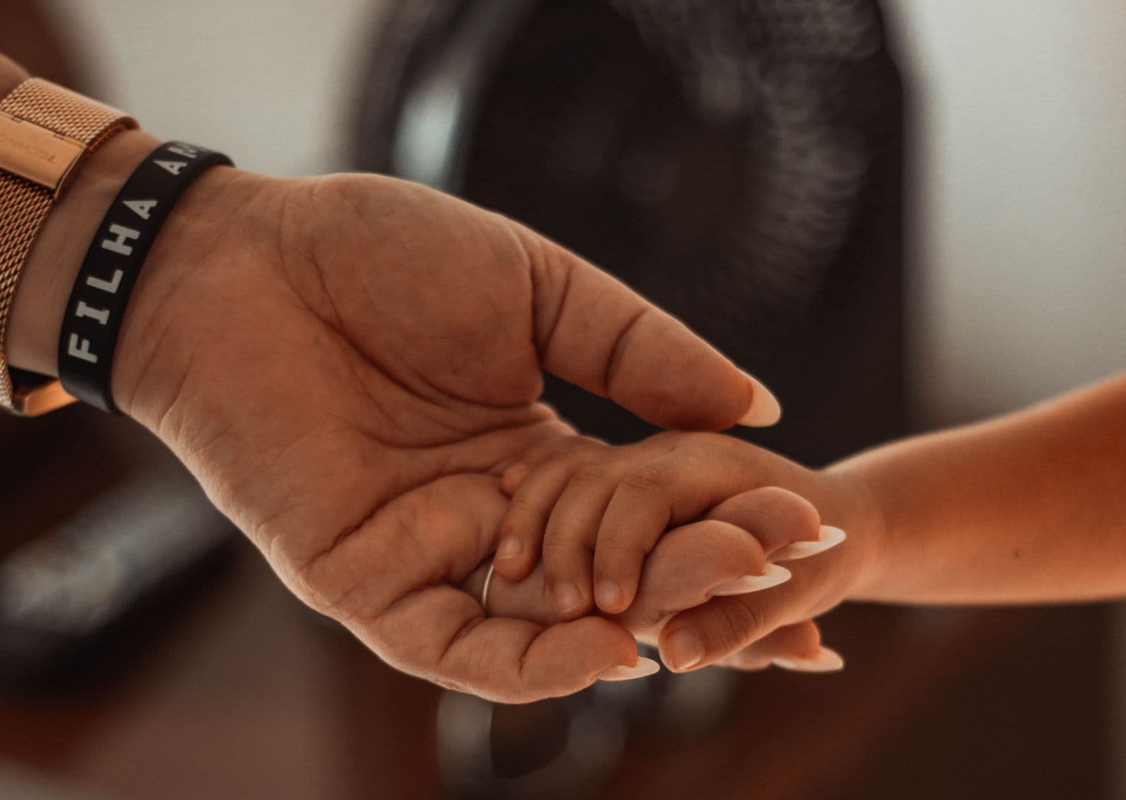 A parent's hands gently cradling a young child's hand, reflecting the families awaiting the FDA's decision on the first Sanfilippo syndrome treatment.