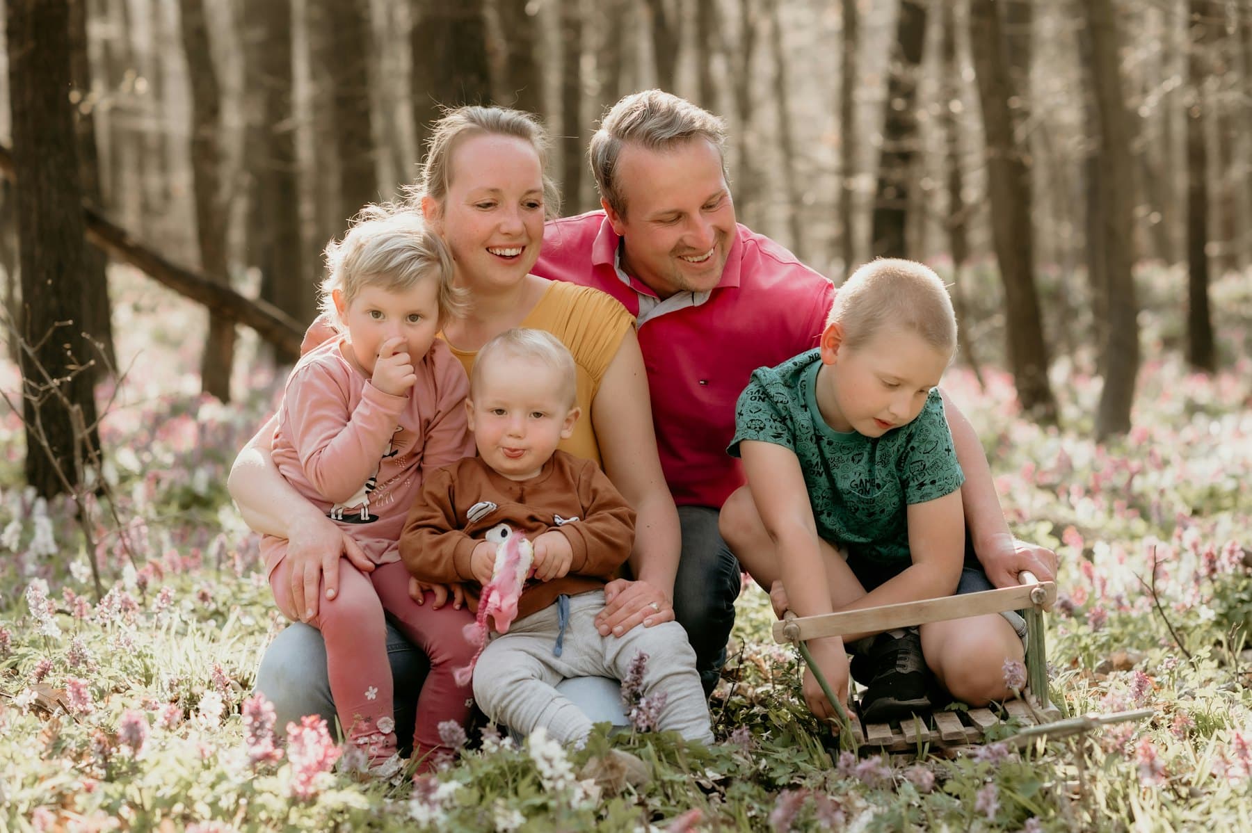A group of people sitting in the grass