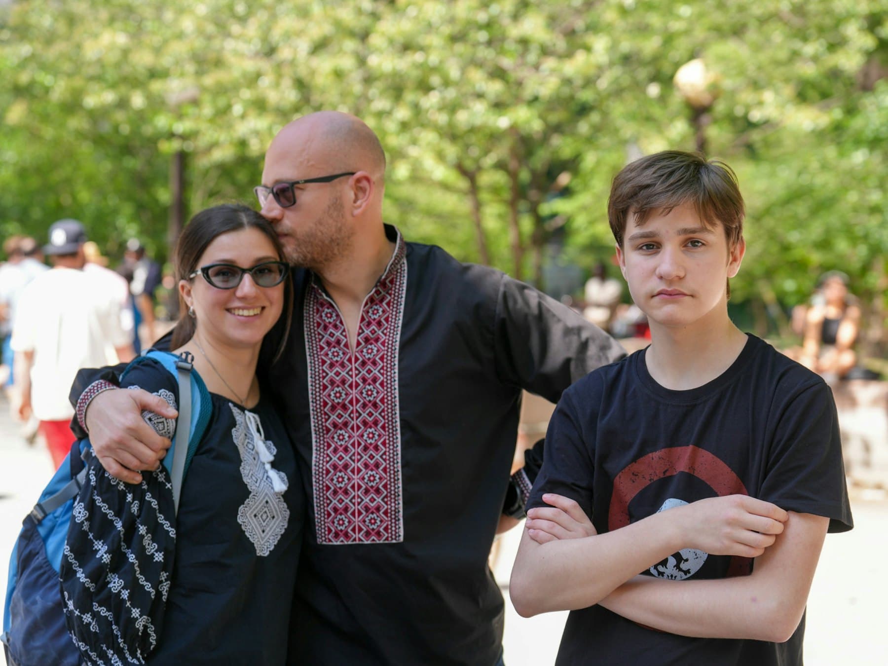 Two parents and a teenager in a park